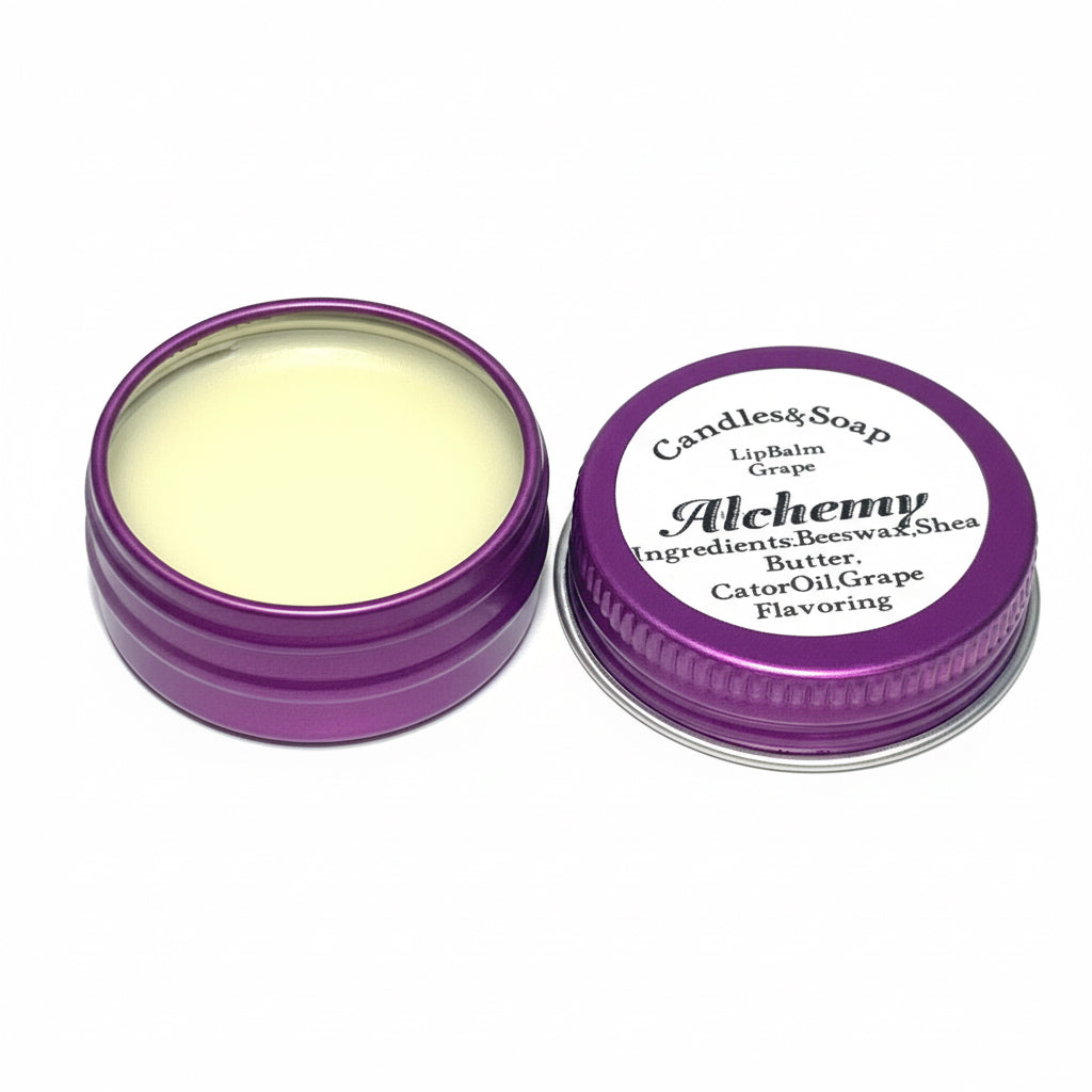 A small open container of lip balm with a label that reads 'Alchelmy Lip Balm' next to a closed lid with the same label.