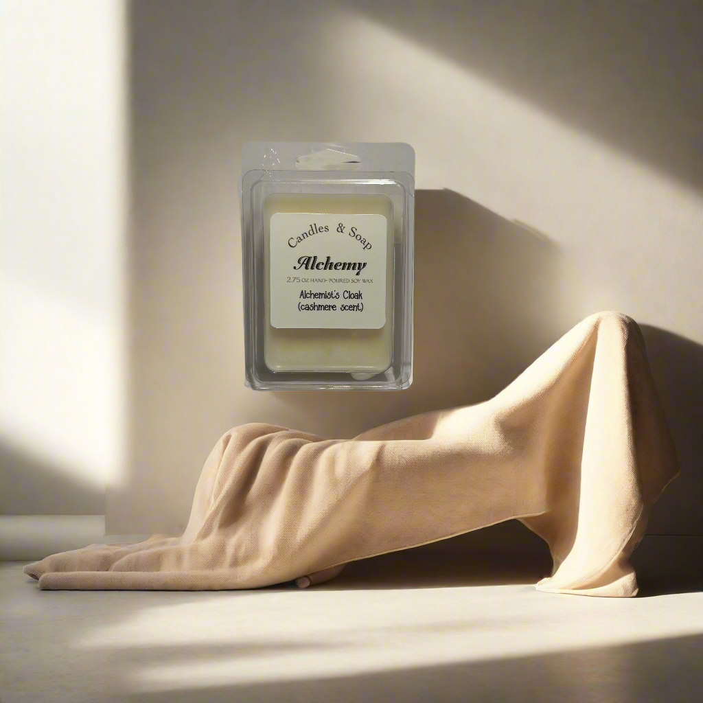Wax melt in a clear container labeled 'Alchemy' on a white background