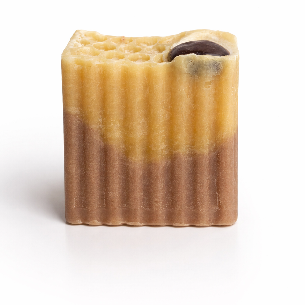 Bar of soap with a chocolate chip on a white background