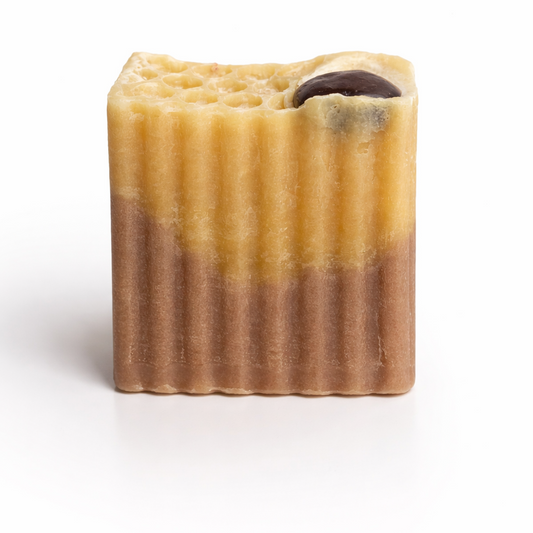 Bar of soap with a chocolate chip on a white background