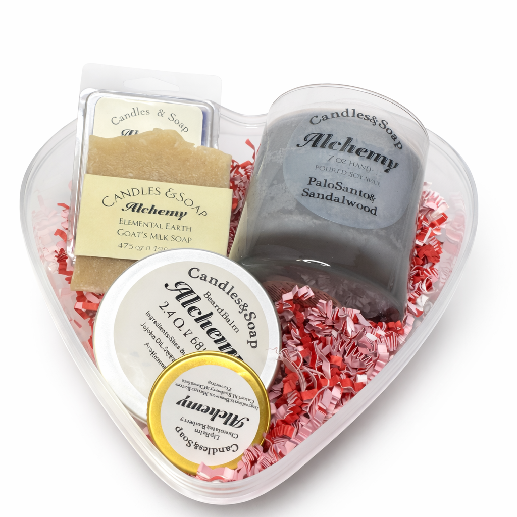 Heart-shaped container with bath products including a bar of soap, a loaf of bread, and a jar labeled 'Alchemy'.