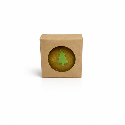 Small green tree-shaped object inside a brown cardboard box on a white background