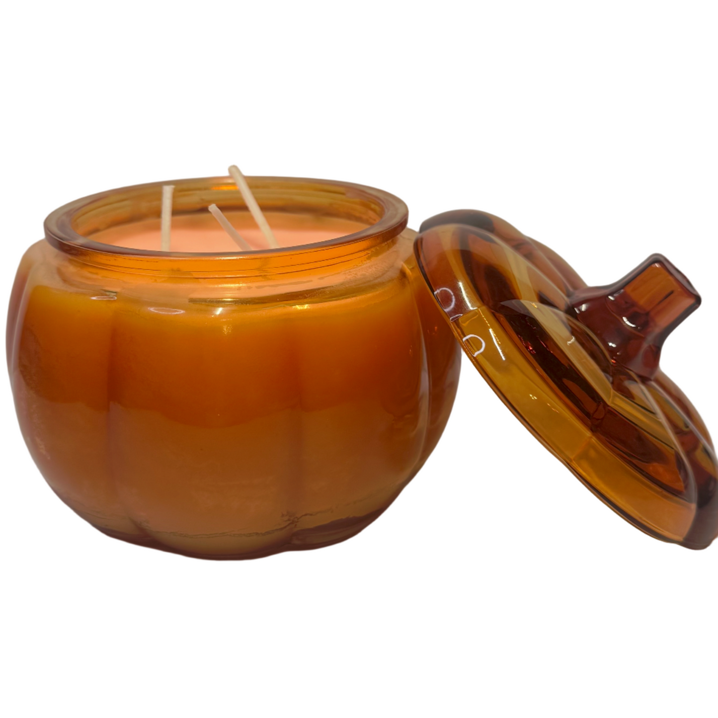 Pumpkin-shaped candle with a lid on a white background
