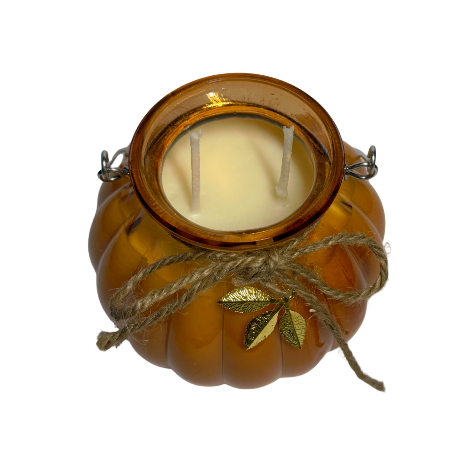 Candle in a pumpkin-shaped jar with a leaf decoration on a white background