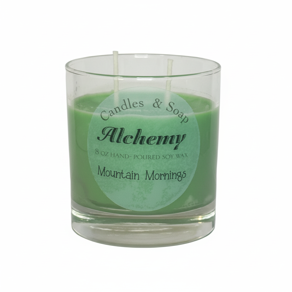 Candle in a glass jar with 'Alchemy' label on a white background