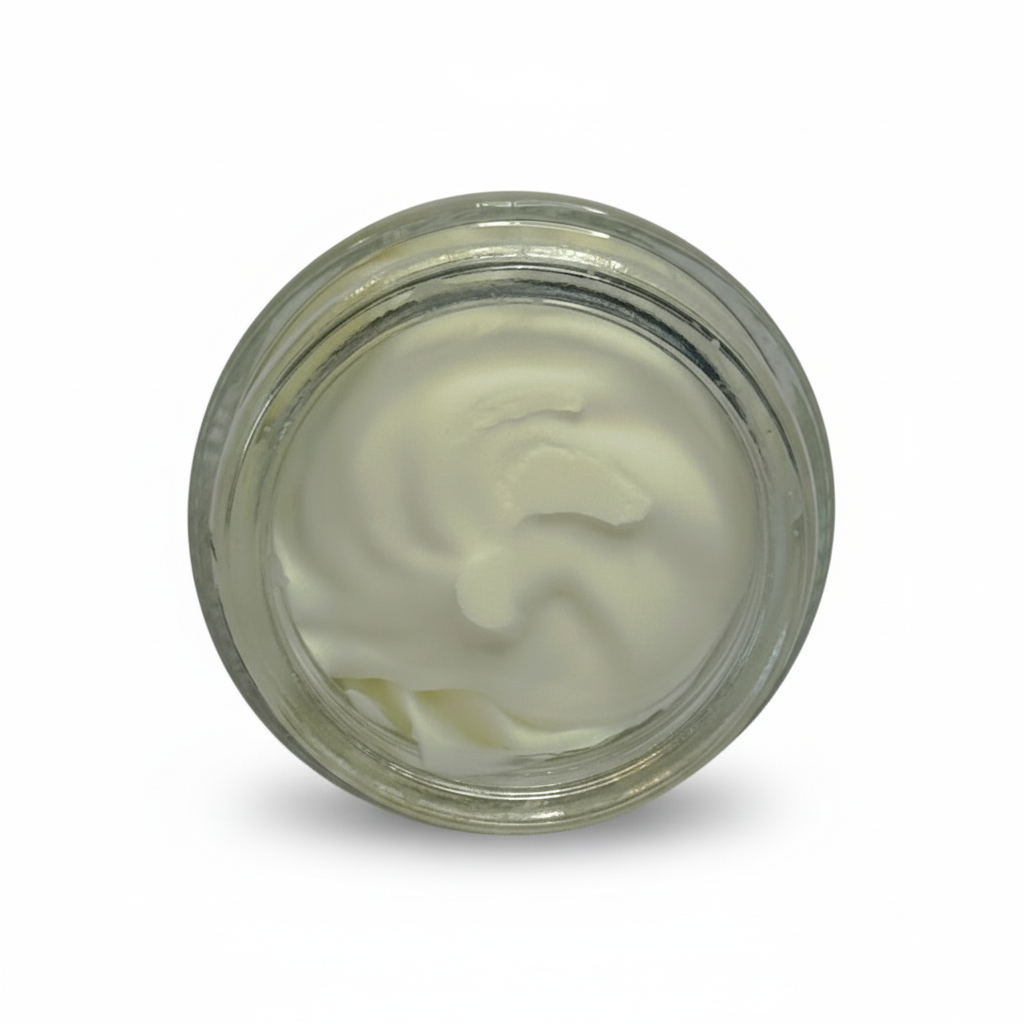 Clear glass jar with white cream-like substance on a gray background