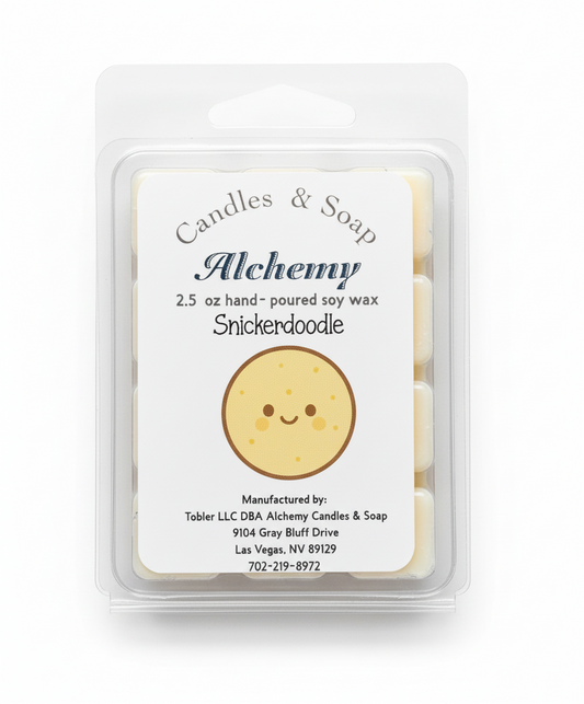 Wax melt package with 'Alchemy' branding and a smiley face design on a gray background