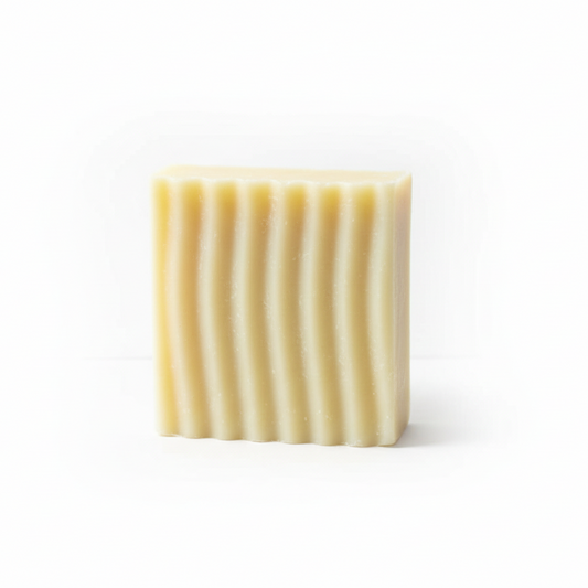 Rectangular bar of soap with wavy texture on a white background