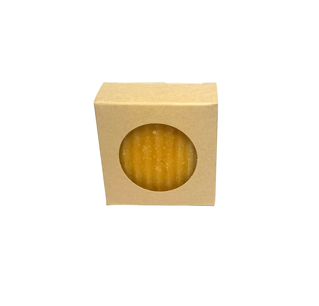 Bar of soap in a beige box on a gray background