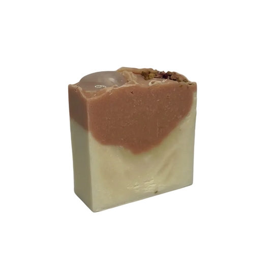 two tone soap with pink and white, topped with rose quartz heart shaped crystal and rose petals.