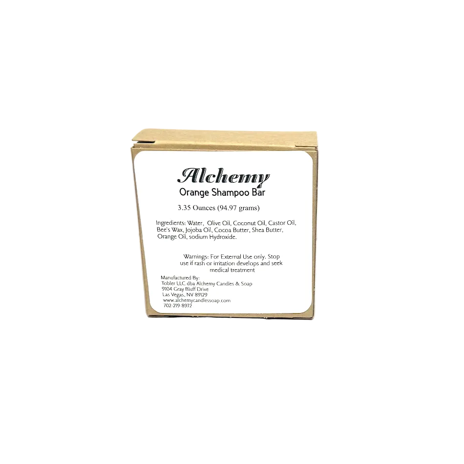 Alchemy Orange Shampoo Bar packaging on a gray background
