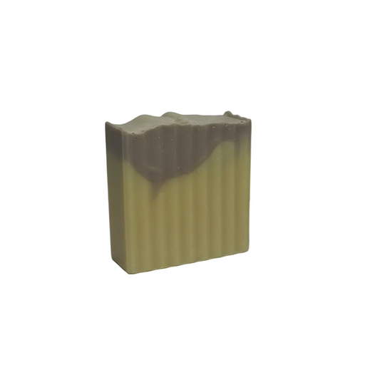 Rectangular bar of soap with a ribbed texture on a gray background