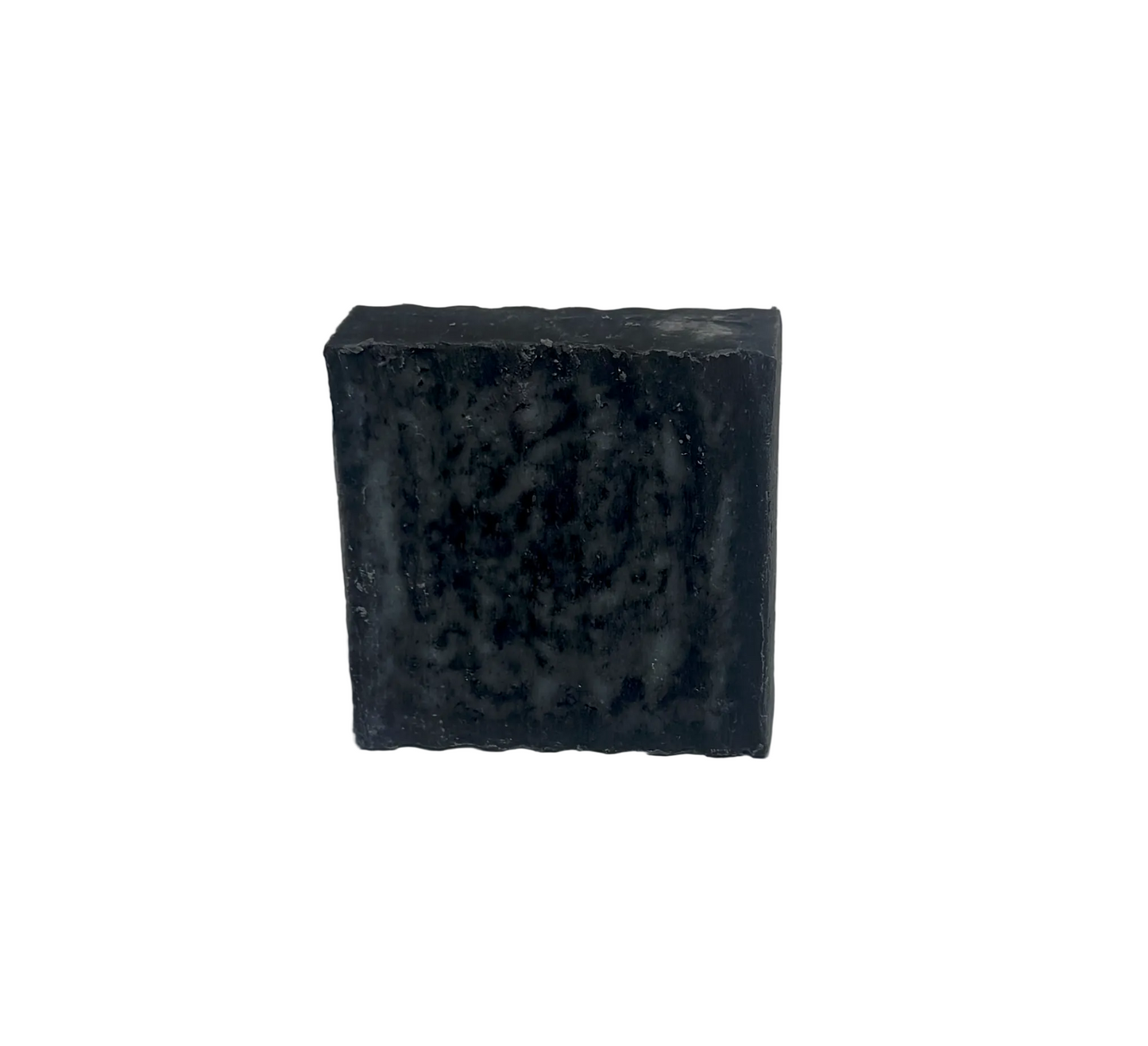Bar of dark gray soap on a white background