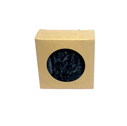 Beige box with a circular window displaying a speckled blue and gray pattern on a white background