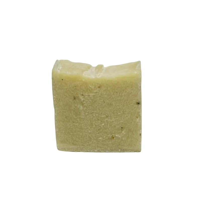Square block of light-colored soap on a gray background
