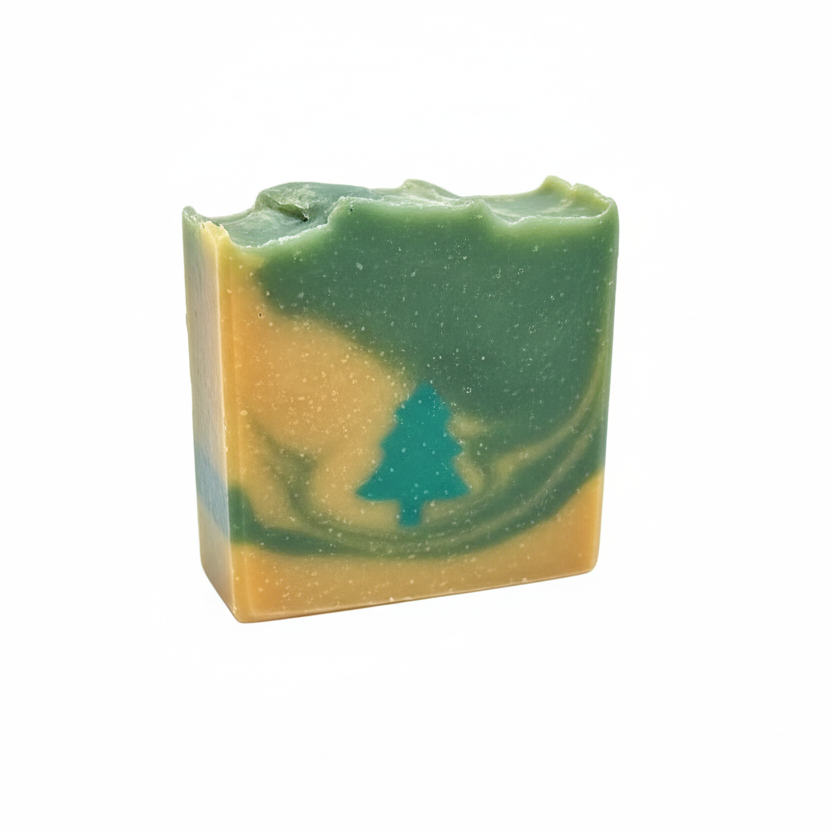 Bar of soap with green and beige coloration on a gray background