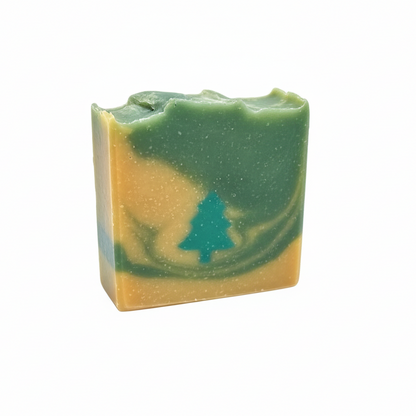 Bar of soap with green and beige coloration on a gray background
